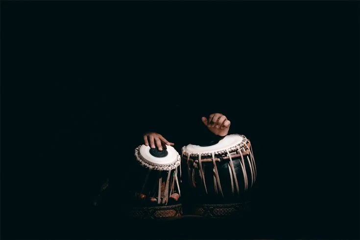 Hands playing tabla drums, live tabla performance